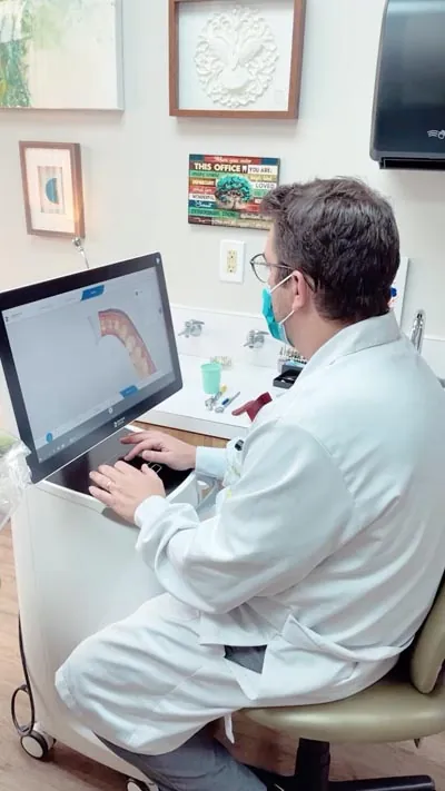 Dr. Oliveira reviewing a patient's dental x-rays